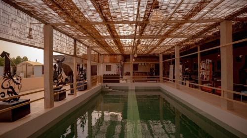 a room with a pool of water in a building at Al Khateem Art Hub in Baţīn