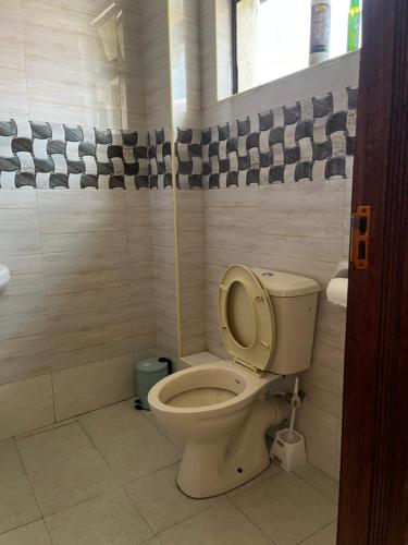 a bathroom with a toilet and a sink at Ramshab apartments A8 in Nairobi