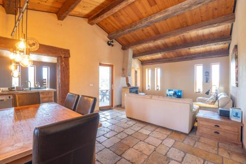 a kitchen and dining room with a table and chairs at Maison Time-out in Villevieille