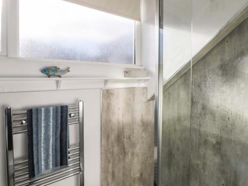 a bathroom with a window and a shower at Skyelands in Wooler