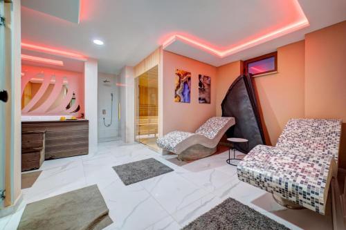 a bathroom with two chairs and a sink at Apartman Premija in Zlatibor