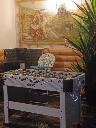 a foosball table in front of a mural at Pokoje Gościnne U Moniki i Daniela in Zakopane