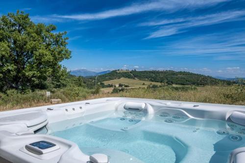 a jacuzzi tub with a view of the mountains at Maison Time-out in Villevieille