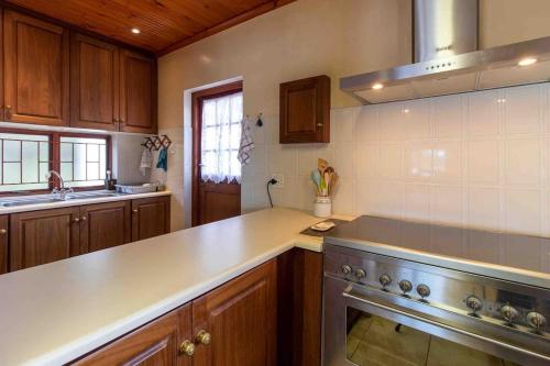 a kitchen with a sink and a stove top oven at River Paradise in Bushmans River Village
