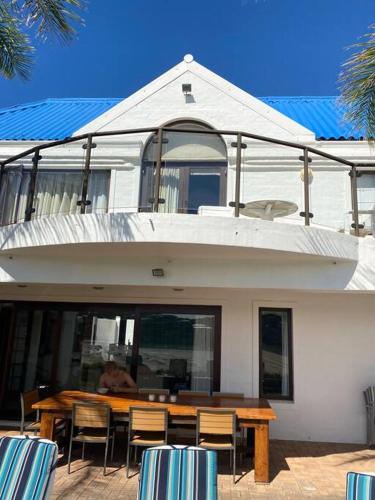 a table and chairs in front of a house at River Paradise in Bushmans River Village