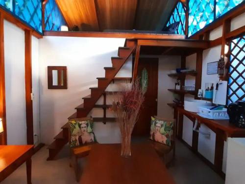 a room with a staircase with a vase on a table at Casa Blanca Beachfront House with Shared Pool Access Pangea Lodge in Manzanillo