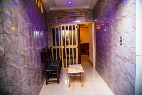 a hallway with a table and chairs in a room at AHoefa in Lomé