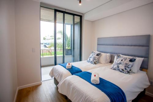 a bedroom with two beds with towels on them at 108 The Meadows in George