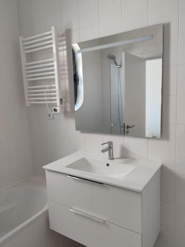 a white bathroom with a sink and a mirror at Villa Palmela Resort V5 Piscina privado in Quinta do Anjo