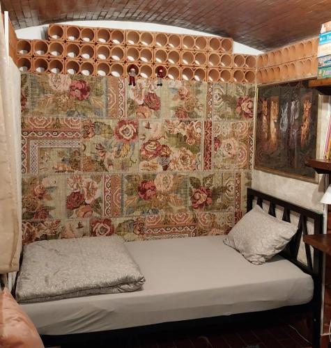 a small bed in a room with a wall at Villa Salviati in Prato