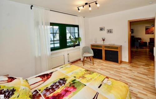 a living room with a bed and a desk in it at FeWo „Im Tal der roten Traube“ in Bad Neuenahr-Ahrweiler