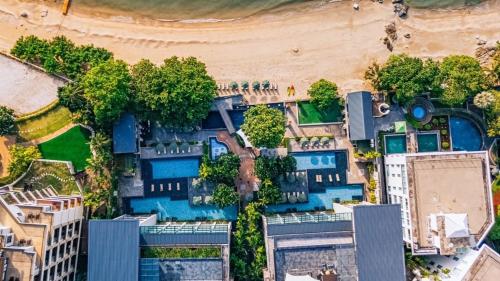 an aerial view of a building with a pool at Pattaya Modus Beachfront Resort in North Pattaya