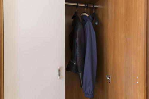 a closet with an umbrella hanging from a door at B&B Hotel Pescara in Pescara