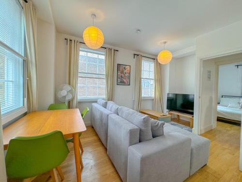 a living room with a couch and a table at Gower street residences in London