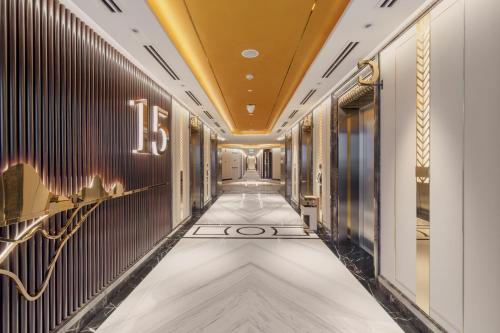 a hallway of a luxury hotel with a tile floor and gold ceilings at Radisson Blu Ha Long Bay in Ha Long