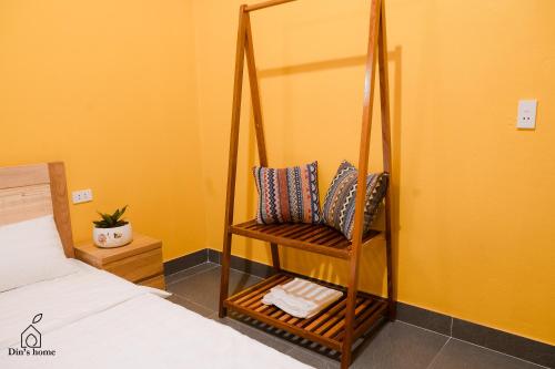 a room with a bed and a chair with pillows at Dìn home in Ha Giang