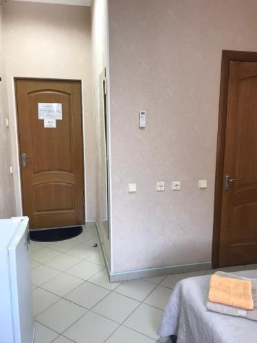 a bathroom with a door and a mirror in a room at Karavella in Mykolaiv