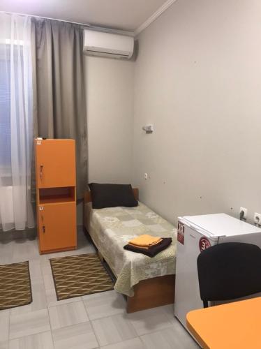 a small room with a bed and a cabinet at Karavella in Mykolaiv