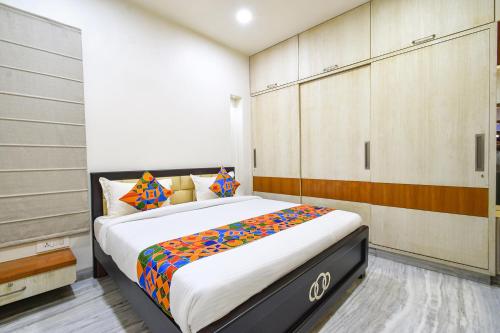 a bedroom with a large bed in a room at FabHotel De Alphabet II - Nr Ameerpet Metro Station in Hyderabad