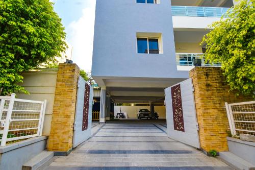 a building with a gate and a walkway at FabHotel De Alphabet II - Nr Ameerpet Metro Station in Hyderabad