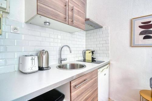 une cuisine avec un évier et un plan de travail dans l'établissement Studio proche Alesia - Thibaud - II, à Paris