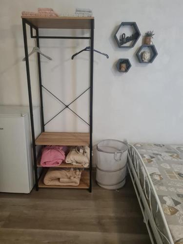 a room with a bed and a shelf next to a bed at Casa Lucia Ortigia in Syracuse