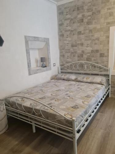 a bed in a room with a mirror at Casa Lucia Ortigia in Syracuse