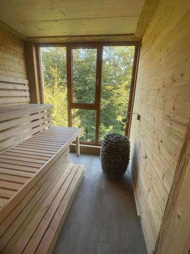 a room with two benches and a large window at Hotel Kreuzbergbaude beim Berzdorfer See mit Wohlfühl Sauna in Görlitz