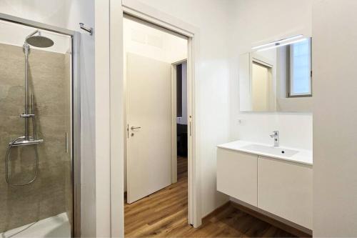 a white bathroom with a sink and a shower at Bilocale centro storico in Novara