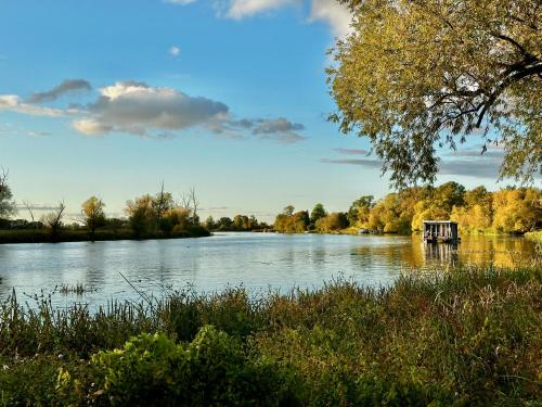 a lake with a small boat in the middle at Das BilderbuchCafe - Pension Markt 7 in Havelberg