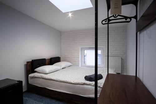 a bedroom with a bed and a table and a window at Dream Aparts - Wschodnia 34 in Łódź