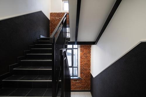 a staircase in a building with black and white at Dream Aparts - Wschodnia 34 in Łódź