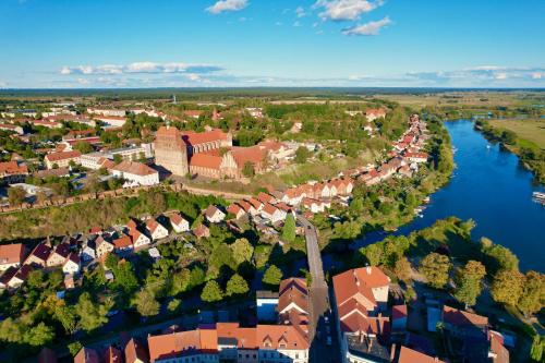an aerial view of a town next to a river at Das BilderbuchCafe - Pension Markt 7 in Havelberg
