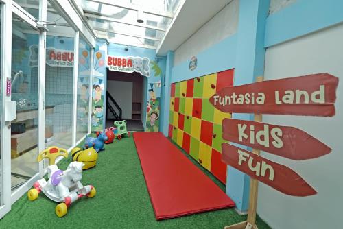 a childrens play area with a sign and toys at Grand Tjokro Yogyakarta in Yogyakarta