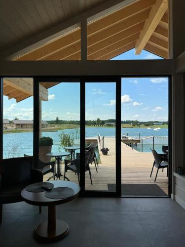 a screened porch with a view of the water at Royal Horse Resort in Balkasodis