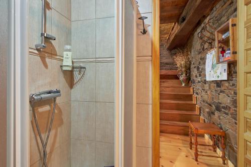 a bathroom with a shower and a staircase at Casa Rural Tio Eloy in Fabero