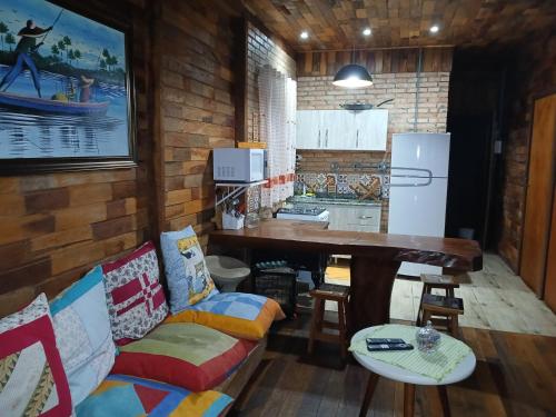 a kitchen with a couch and a table in a room at Casa de campo Blumenau, 21km da vila germânica in Blumenau