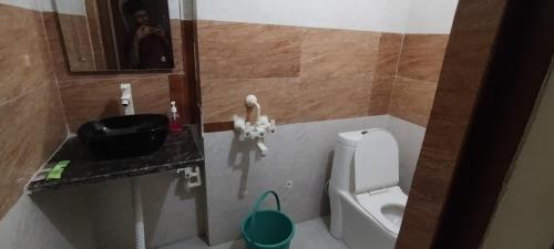 a small bathroom with a sink and a toilet at Sunrise Homestay Agra Near Taj Mahal in Agra
