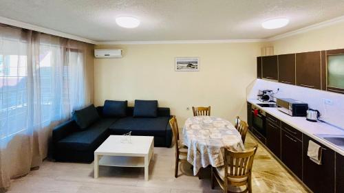 a living room with a couch and a table at Beach Apartments Pomorie in Pomorie