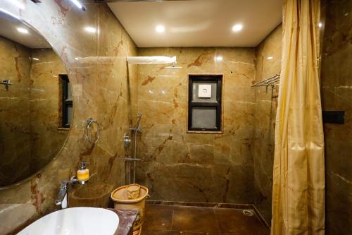 a bathroom with a shower and a sink at Myestay Elite The Ultimate Luxury Spacious Villa in Varanasi