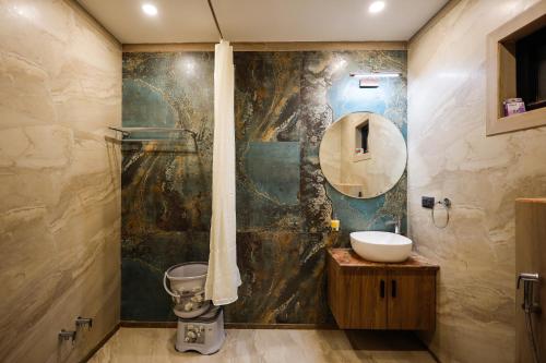 a bathroom with a sink and a mirror at Myestay Elite The Ultimate Luxury Spacious Villa in Varanasi