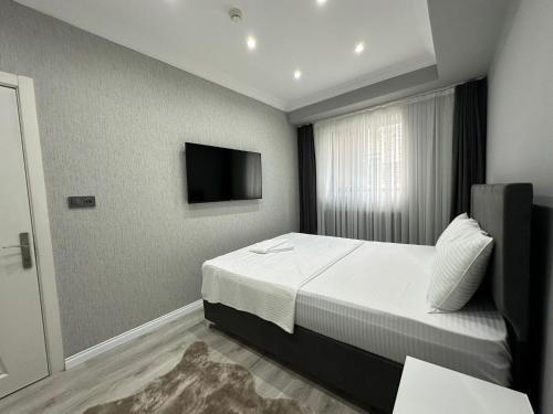 a bedroom with a bed and a television in it at Casa Florya Travel Apartments in Istanbul