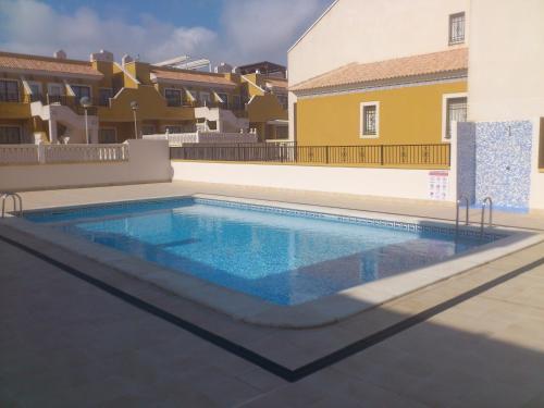 a swimming pool in the middle of a building at Arenales del Sol in Arenales del Sol