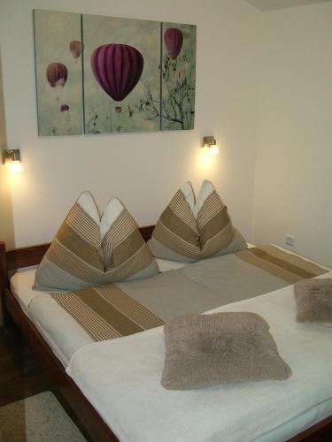 two beds with pillows on them in a room at Korzó Apartman in Kőszeg