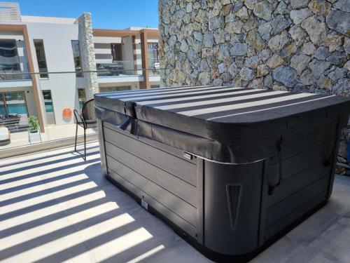 a large black dumpster sitting outside of a building at Utopia Blu Hotel in Tigaki