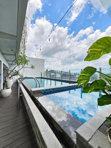 a swimming pool on the roof of a building at Hotel Fortunagrande Jember By Fosia Hotels in Jember
