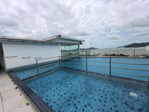 a swimming pool on the side of a building at LANGKAWI JAPANESE STLYE FAMILY DELUXE HOUSE FOR 9Pax New grade in Kuah