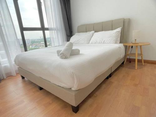 a large bed in a room with a large window at 1min to Paradigm Mall 2to 5pax Platino MujiStyle in Johor Bahru