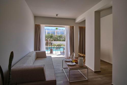 a living room with a couch and a table at Utopia Blu Hotel in Tigaki