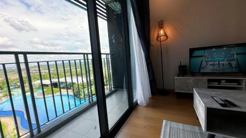 a living room with a view of a balcony at Bandar Gamuda Cove Splash Mania Fully Air Con Suite, 42700 Banting, Selangor in Banting